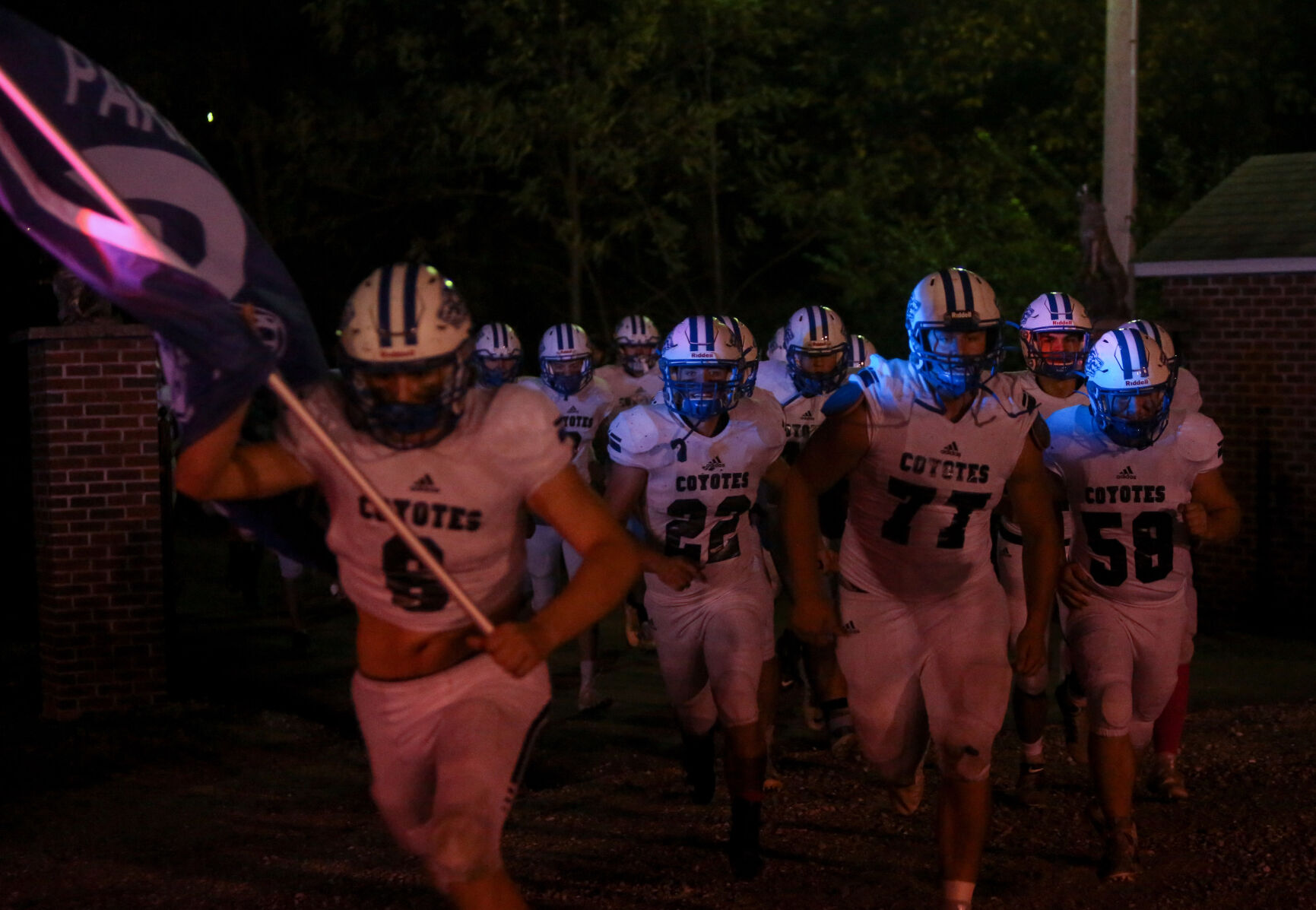 The Paris High School football team runs onto Warbritton Field